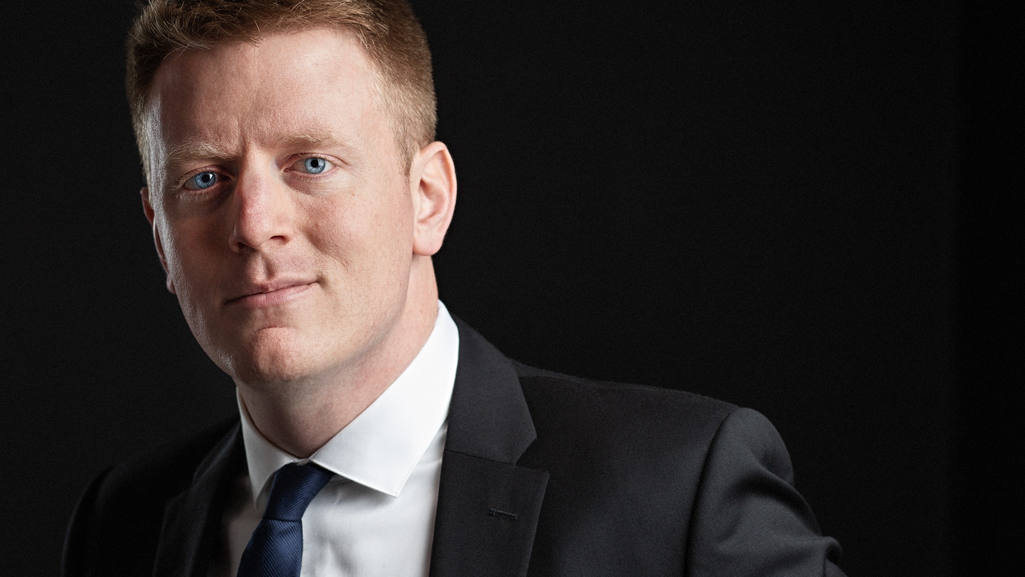 Corporate Headshot of a redheaded businessman with bright blue eyes